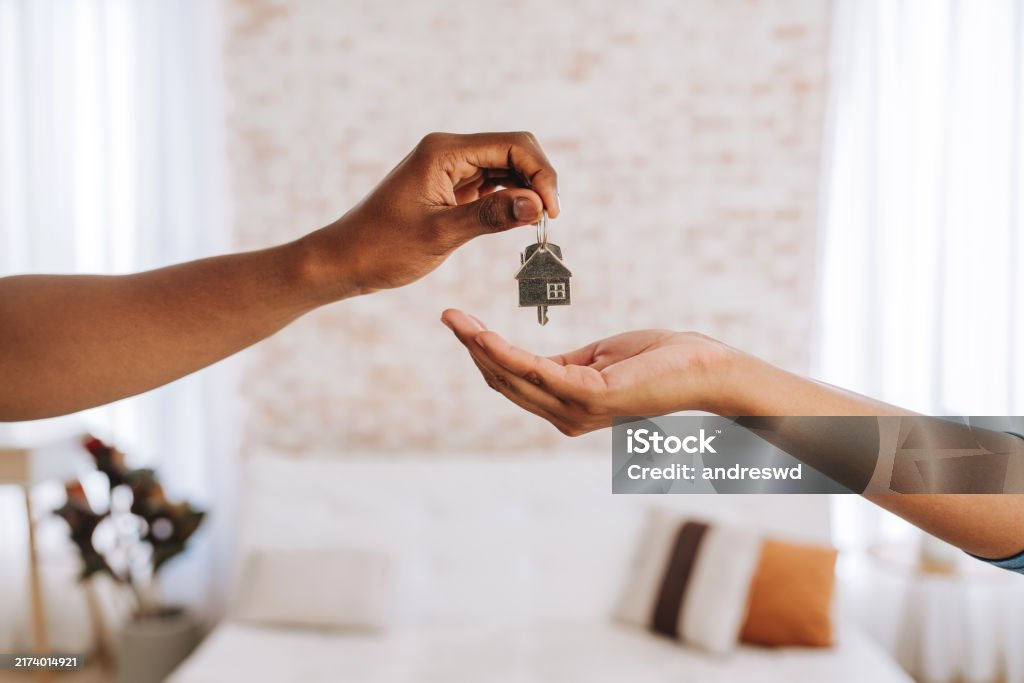 Real estate agent giving a man the keys to his new home