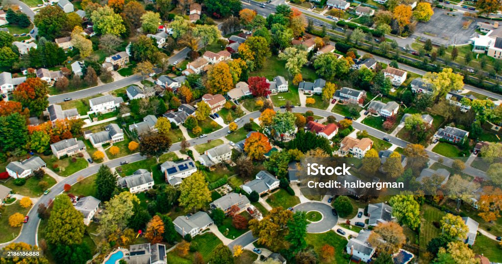 Helicopter shot of the northern suburbs of Washington, D.C. in fall, looking down on residential streets.